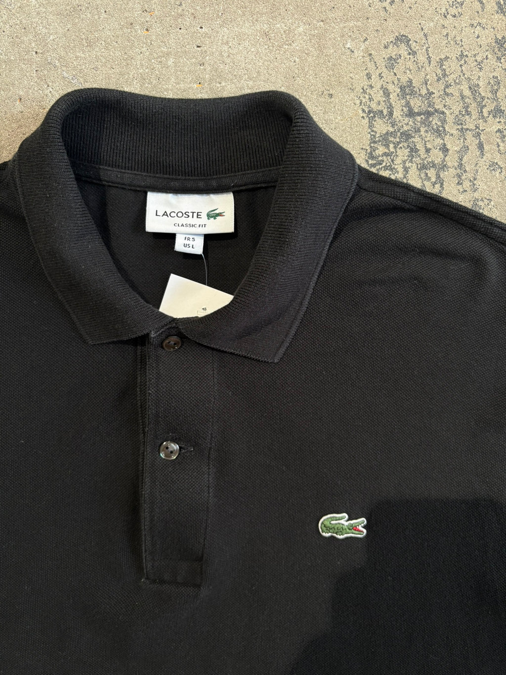 Polo Lacoste nera maniche corte L